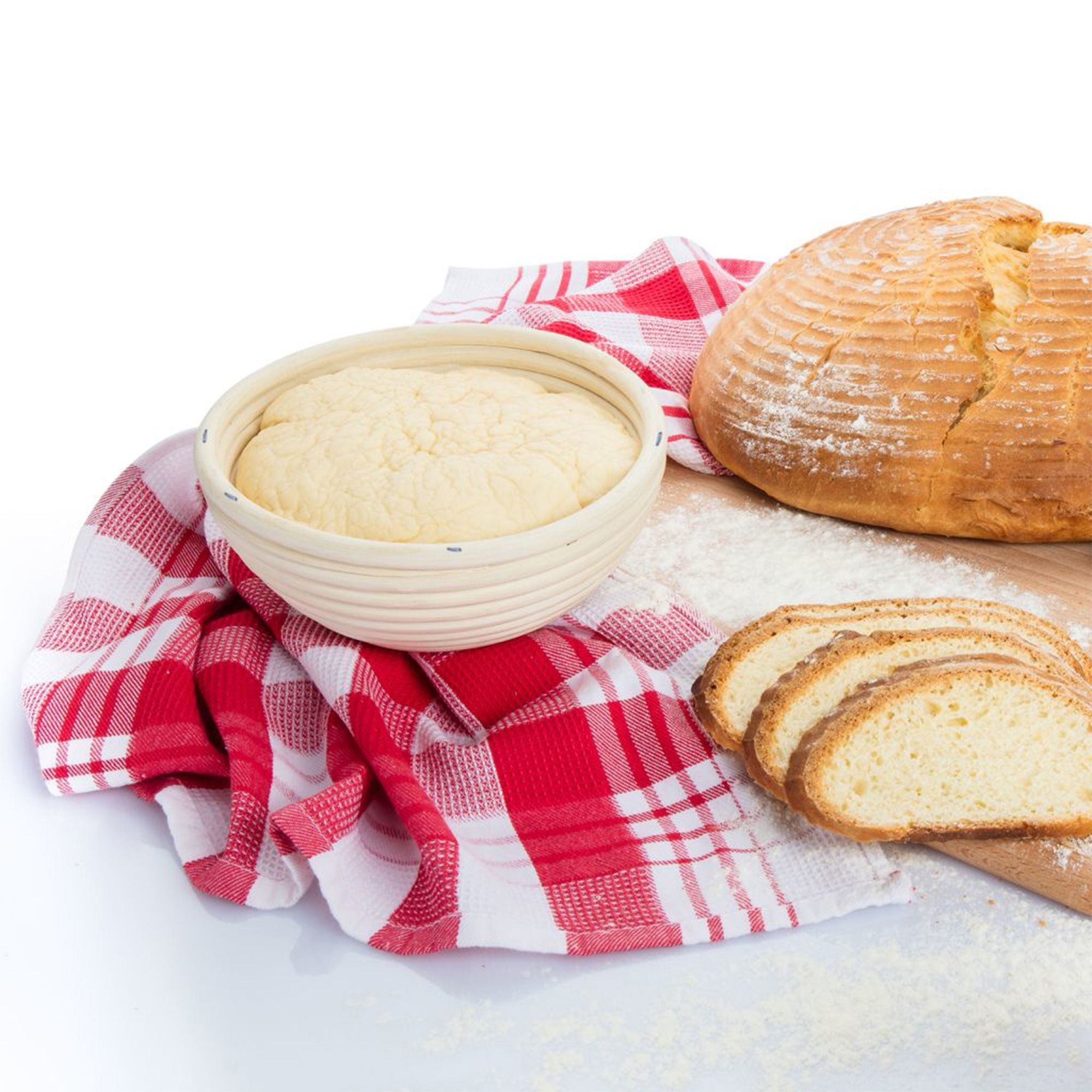 Round proofing basket with dough beside fresh bread
