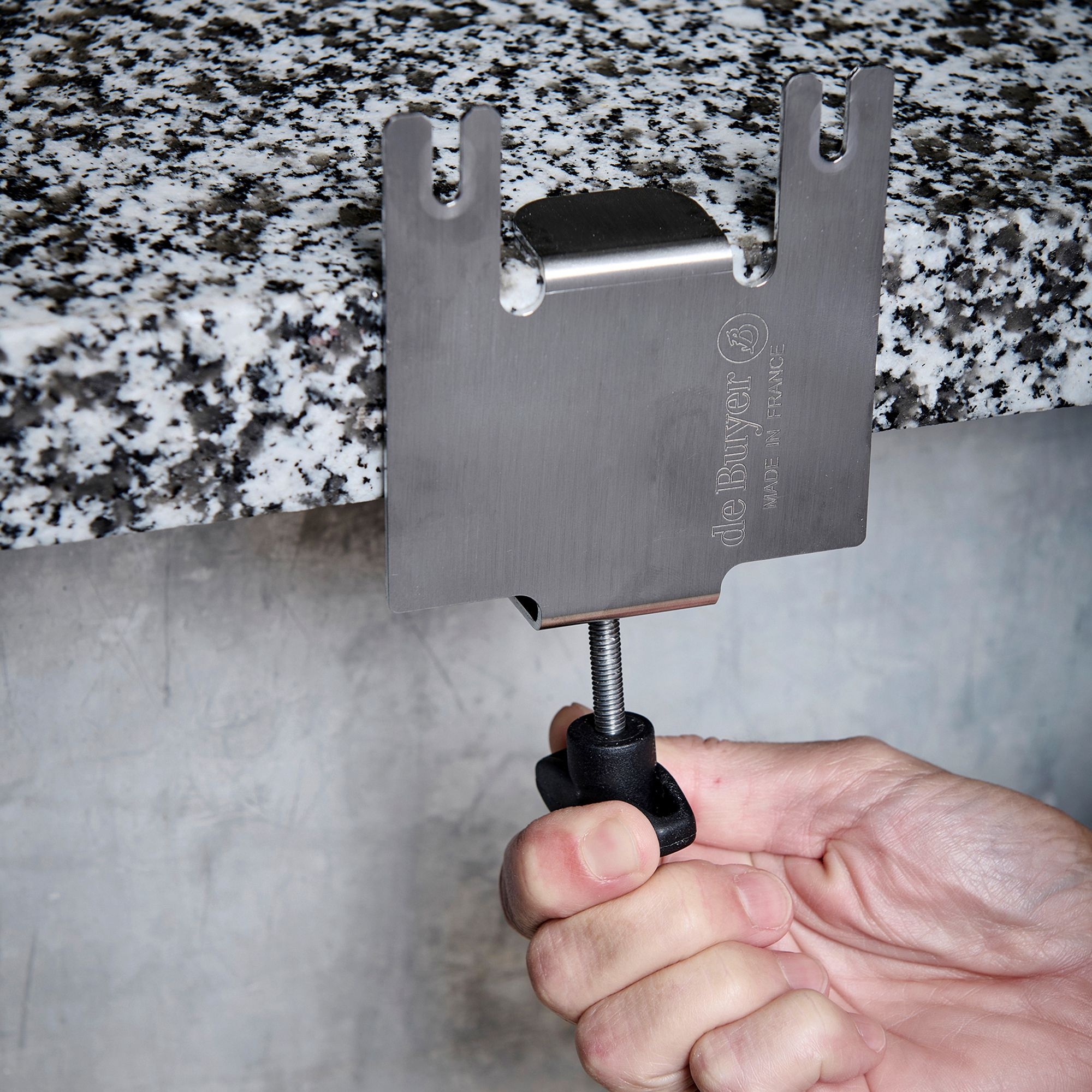 Stainless steel de Buyer table clamp on granite top