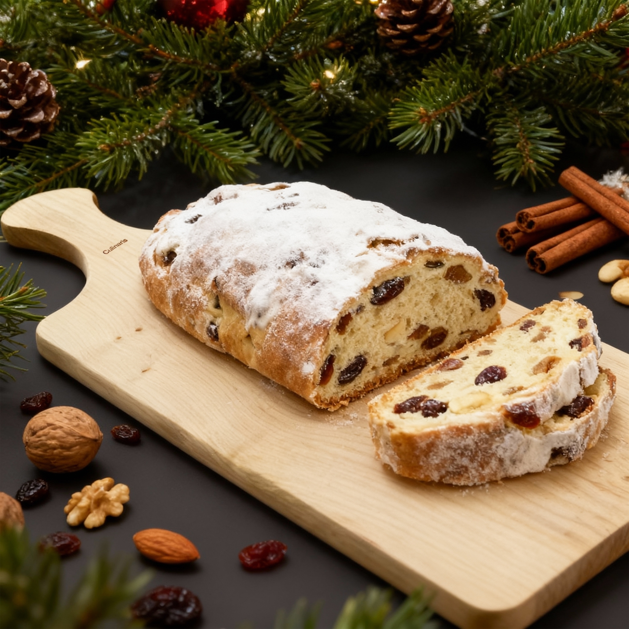 Sliced Christmas stollen on wooden board