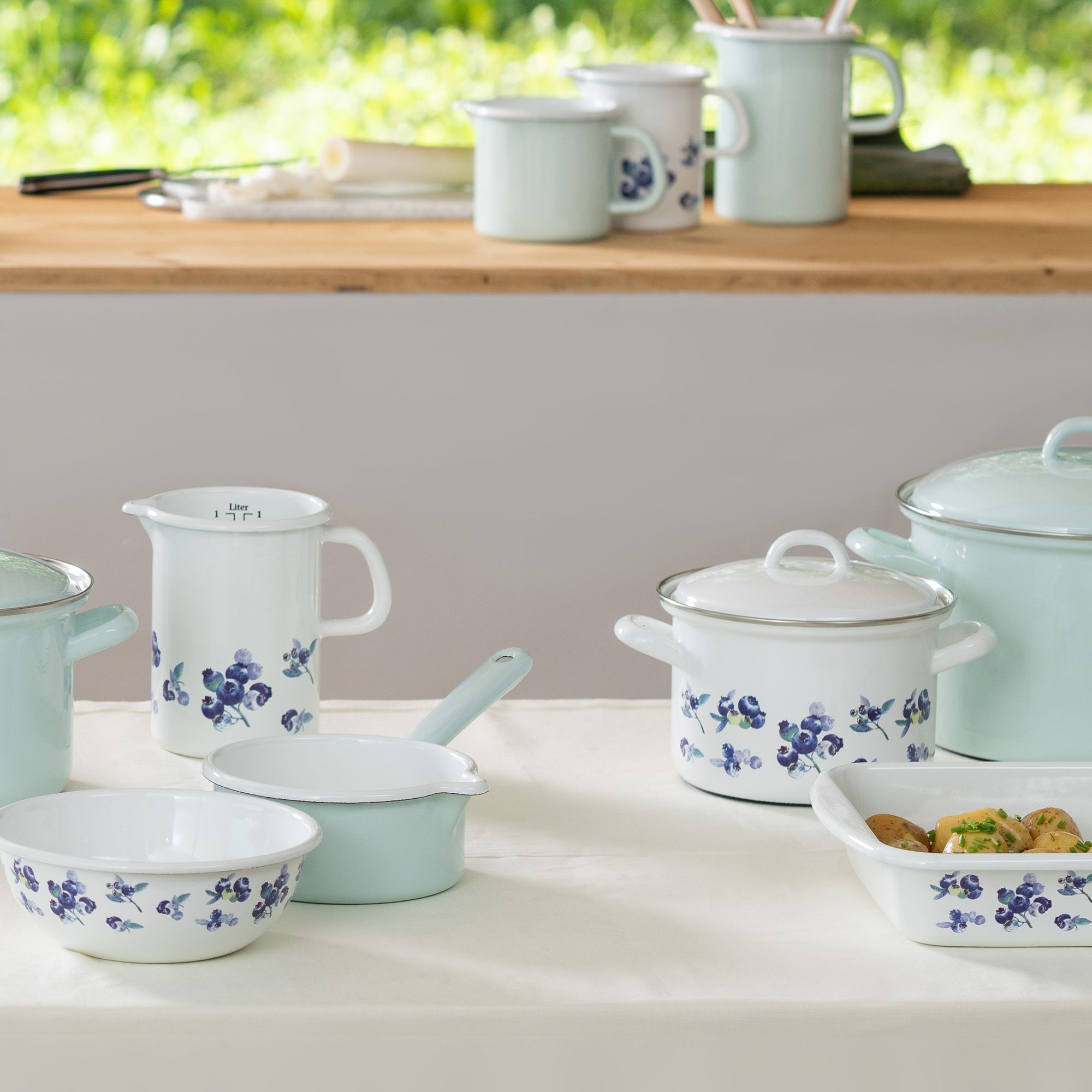 Set of enamel pots and bowls with floral pattern